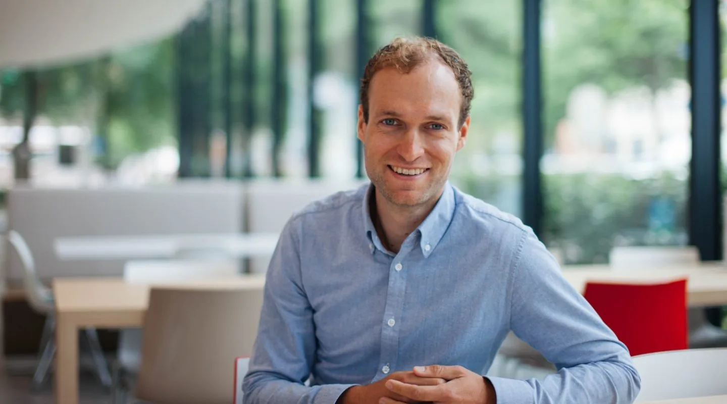 Corporate photography campaign of man sitting at office desk