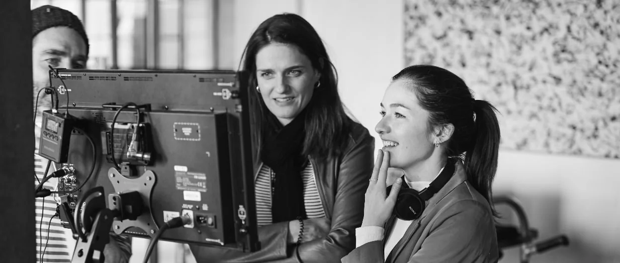Client and video producer on a video set looking at monitor